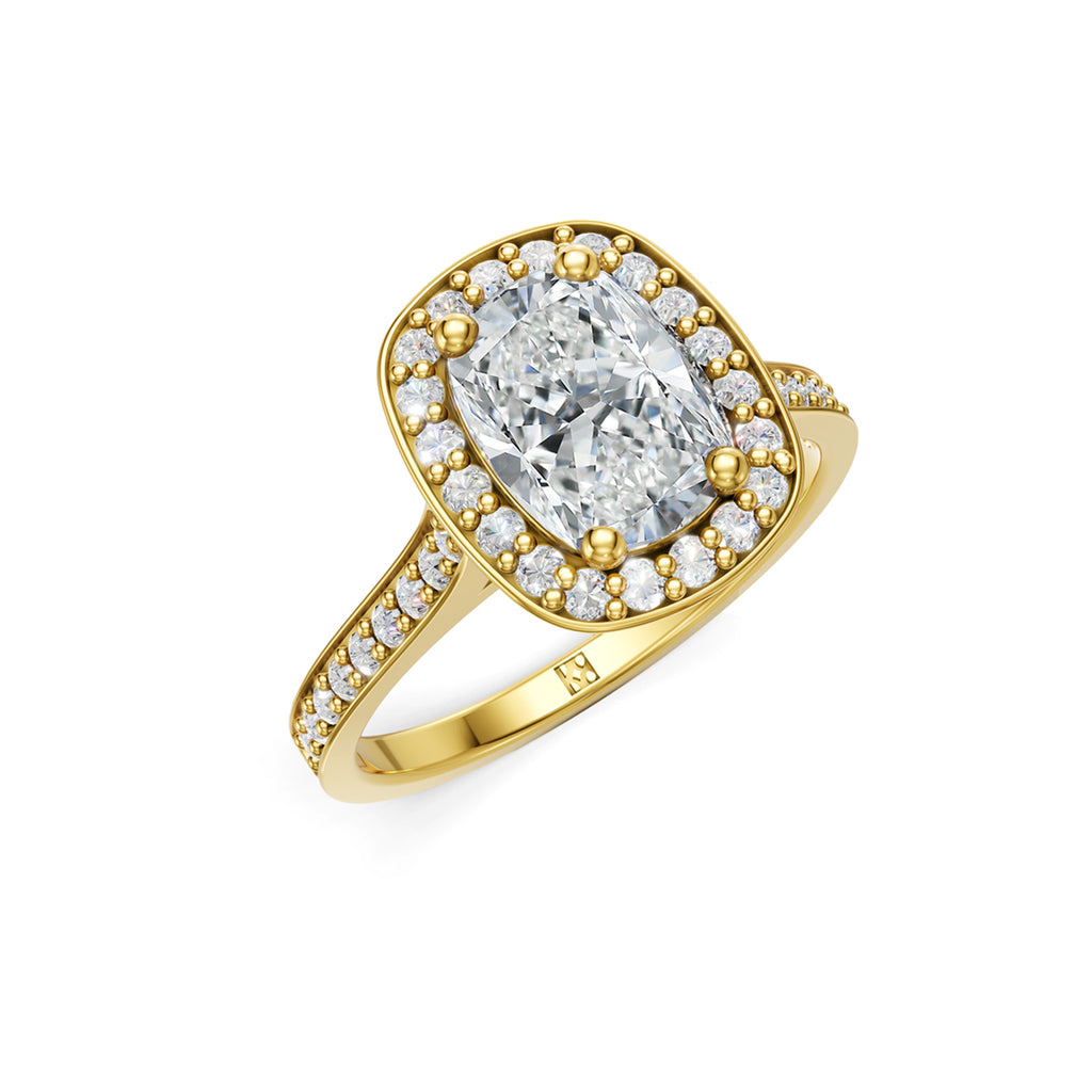 Beautifuly yellow gold diamond halo engagement ring with 2 carat centre diamond and a row of bright, white diamonds running down the engagement ring band. Made in Canada. Bague fiançailles à diamants halo . Création Montréal. Style Couture Classique.