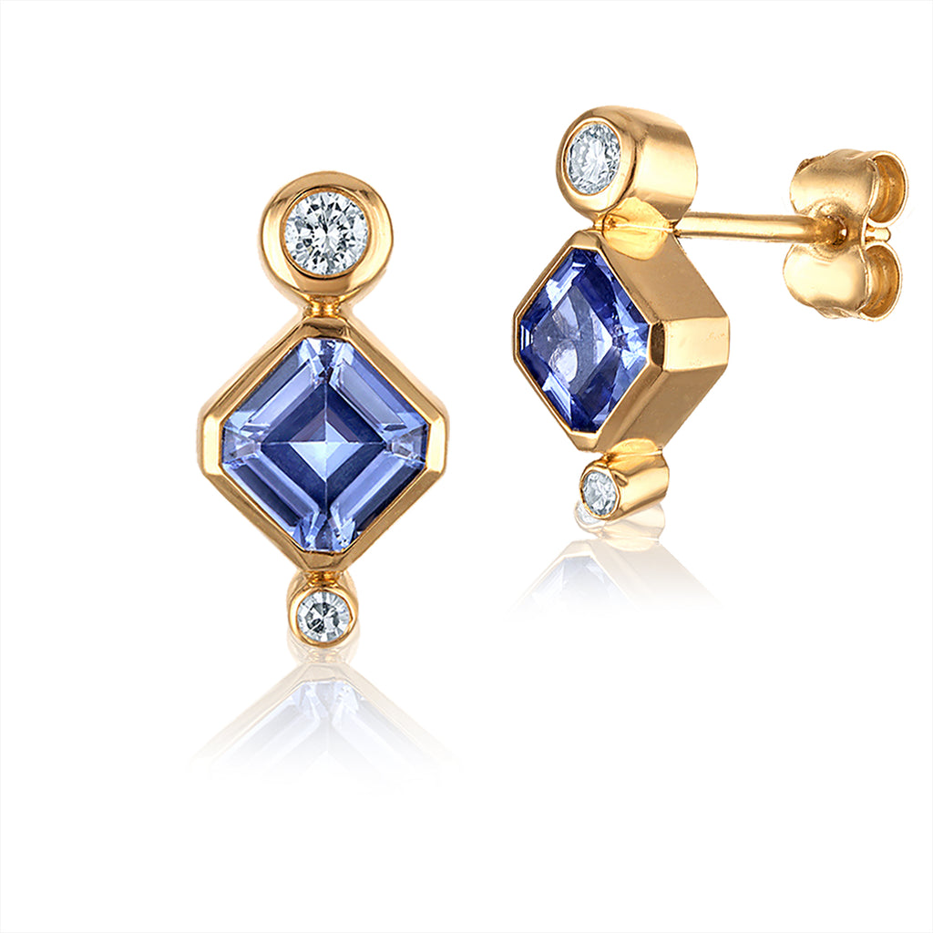 Gold Earrings with Asscher cut Ceylon sapphires and white diamonds on a white background.  Boucles d'oreilles en or à saphira et à diamants sur fond blanc. Montréal, Canada.