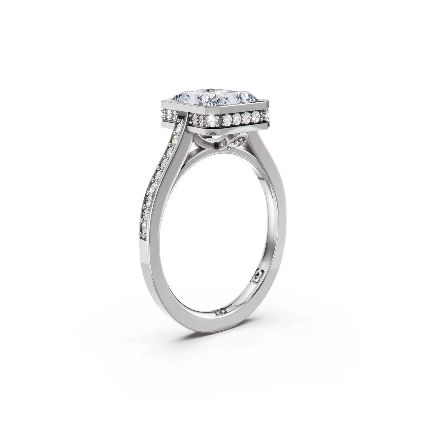Beautiful white gold or platinum radiant diamond bezel engagement ring with hidden halo, 2 carat centre diamond and a row of bright, white diamonds running down the engagement ring band on white background. Made in Canada. Bague fiançailles à diamants avec halo caché et diamants sur l'anneau sur fond blanc. Fabriquée à Montréal. Style serti clos.
