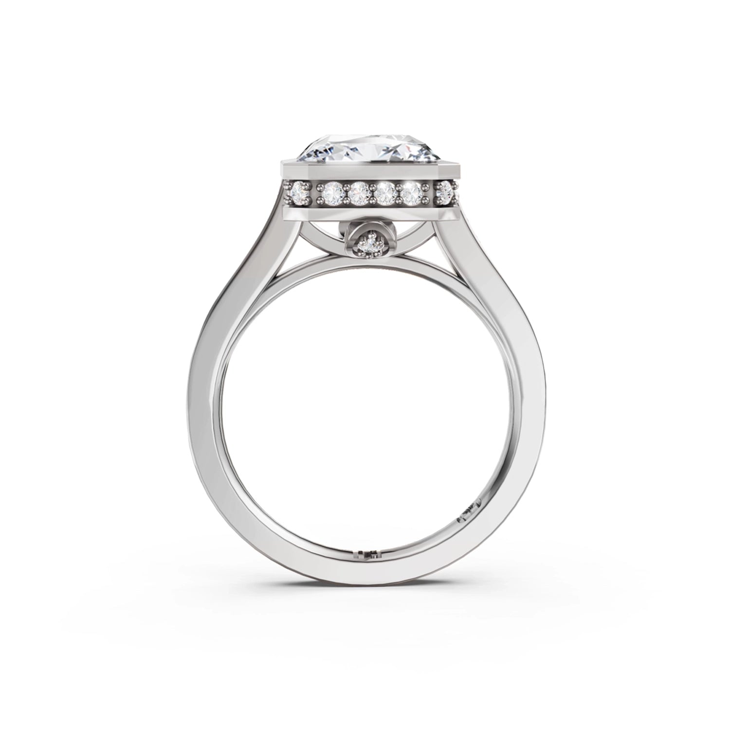 Beautiful white gold or platinum radiant diamond bezel engagement ring with hidden halo, 2 carat centre diamond and a row of bright, white diamonds running down the engagement ring band on white background. Made in Canada. Bague fiançailles à diamants avec halo caché et diamants sur l'anneau sur fond blanc. Fabriquée à Montréal. Style serti clos.