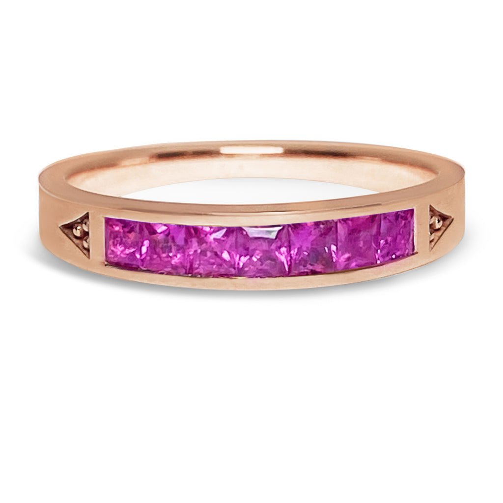 Pink gold stacking ring with 7 princess bright pinks sapphires.