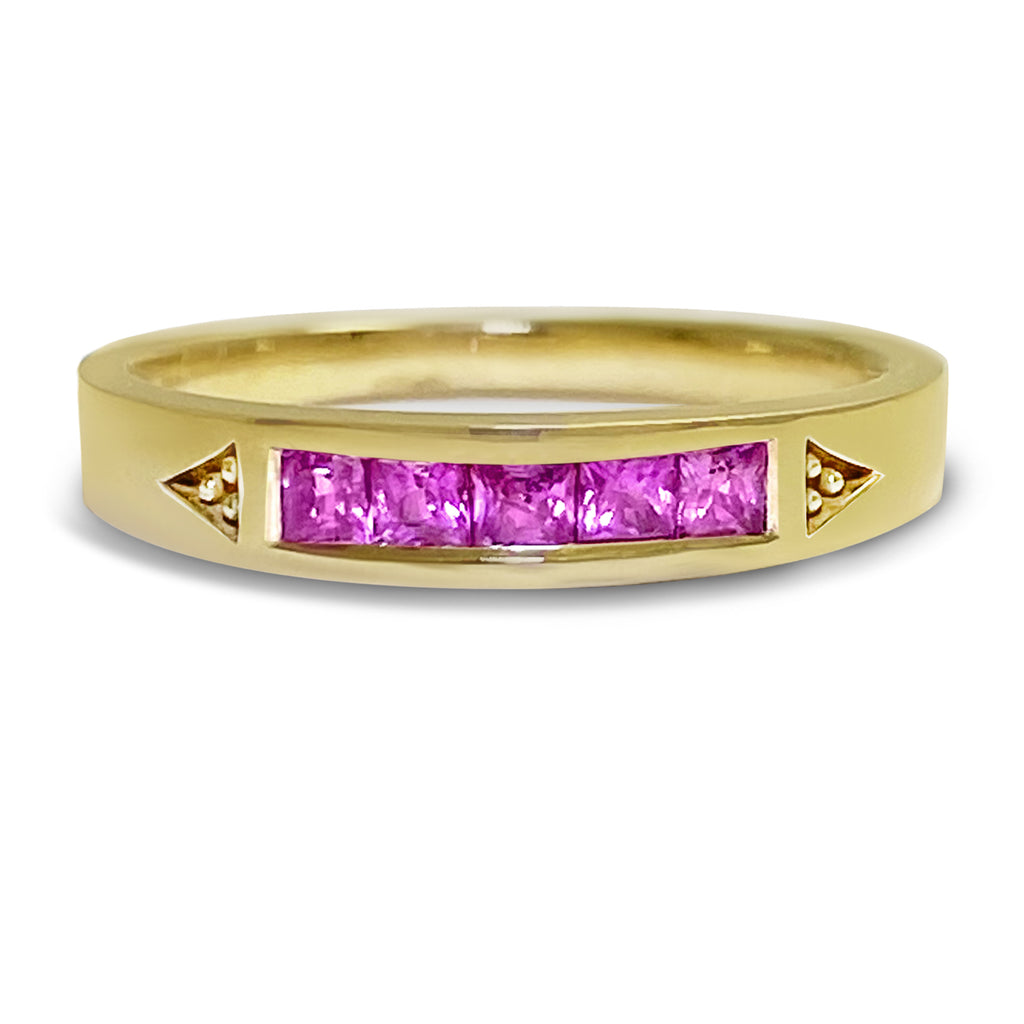 Yellow gold stacking ring with 5 princess bright pinks sapphires.
