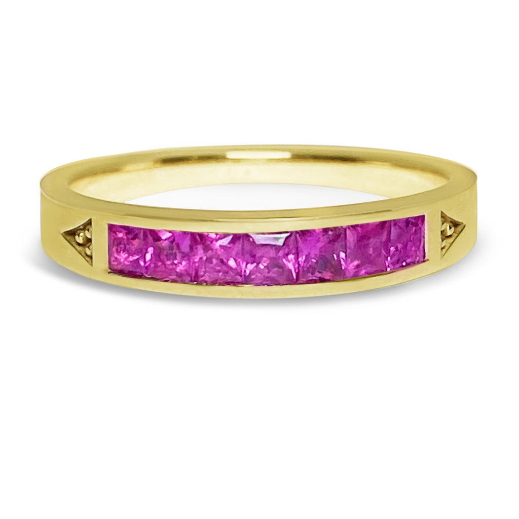 Yellow gold stacking ring with 7 princess bright pinks sapphires.